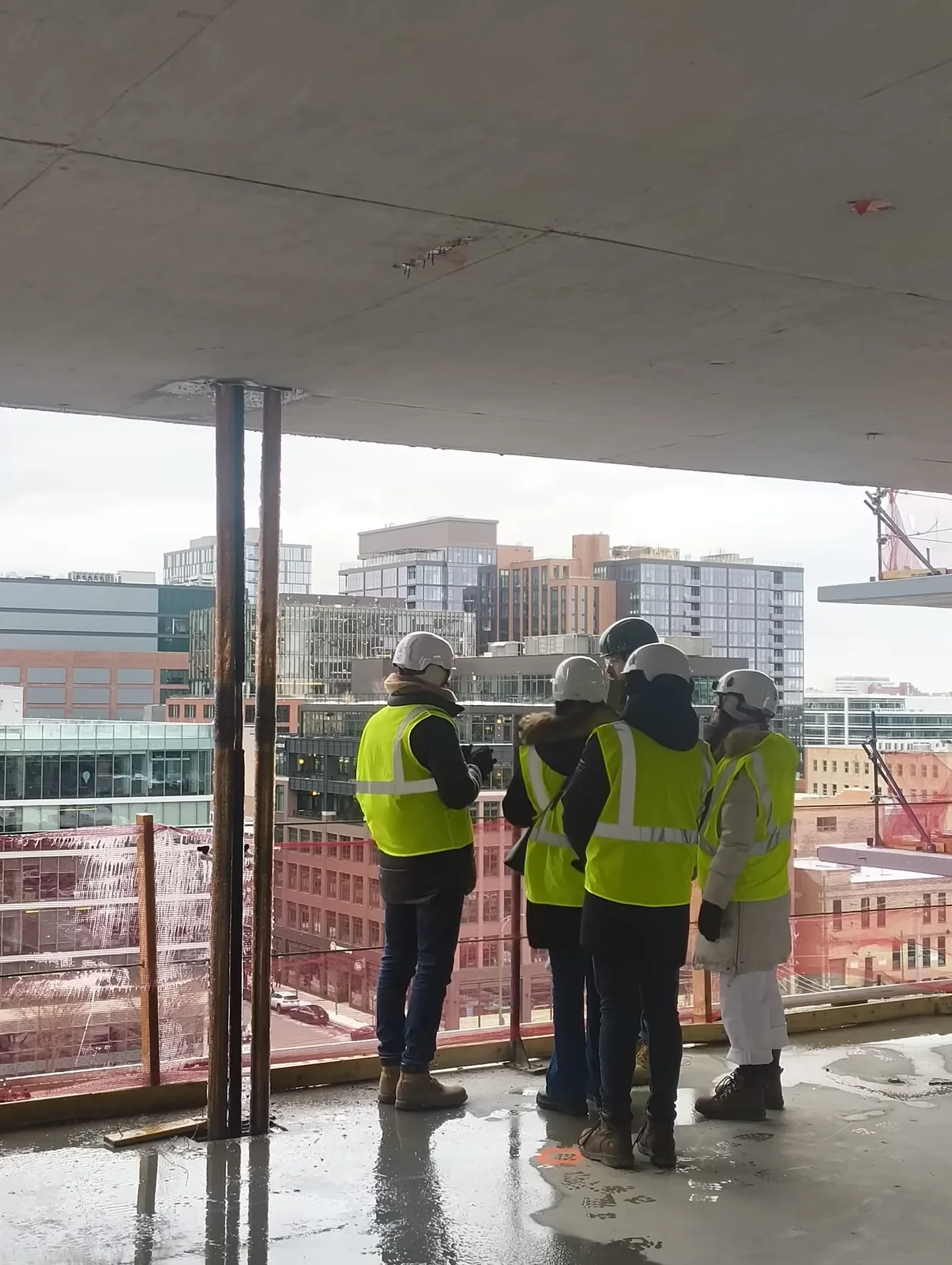 The design team on the tower's structure under construction, looking out over the Dallas skyline.